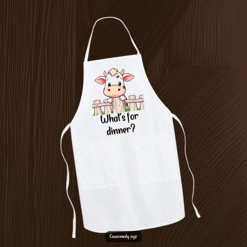 Funny apron depicting a cow curiously peeking over a fence post, ready to add a touch of farmyard fun to cooking.