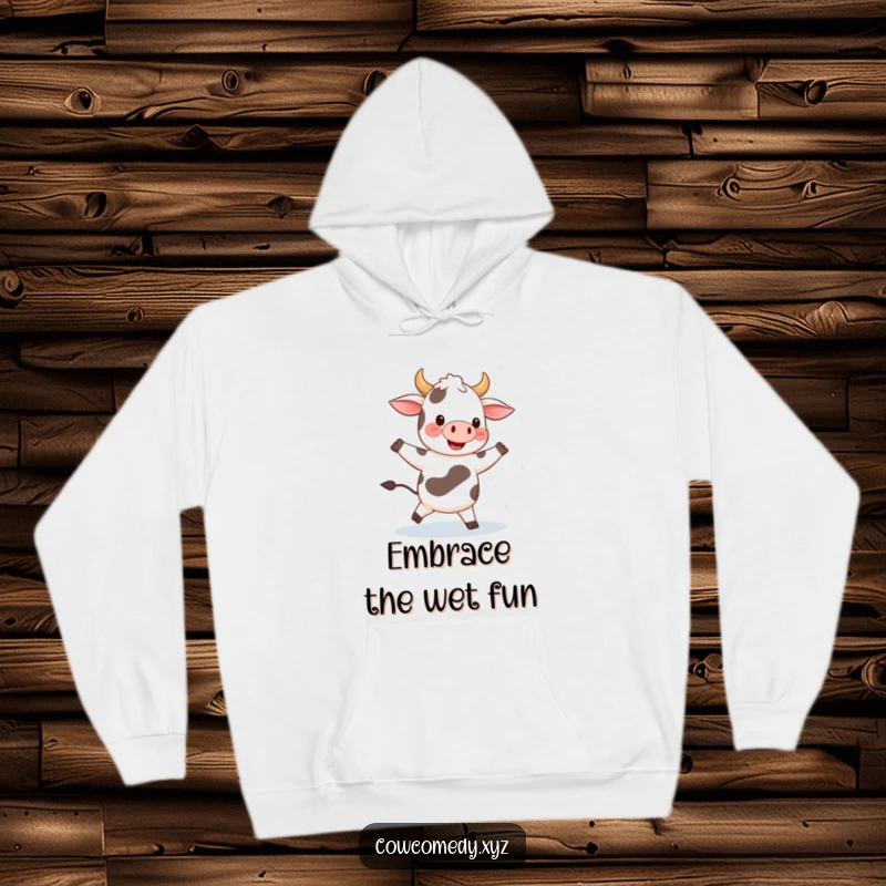 Funny hoodie featuring a smiling cow joyfully dancing in the rain, capturing a moment of pure, unadulterated happiness and carefree spirit.