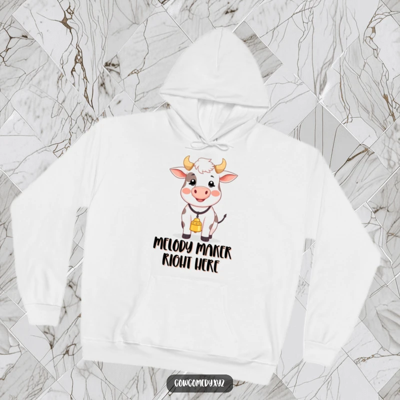 Funny hoodie showcasing a jubilant cow with a bell around its neck, joyfully mooing a melody, bringing warmth and smiles.