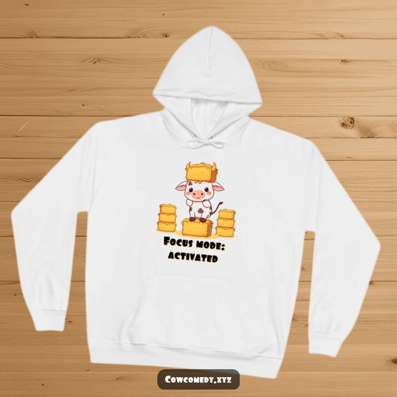 Funny Kawaii Cow Hoodie, a determined cow precariously balancing hay bales, cozy and humorous design.