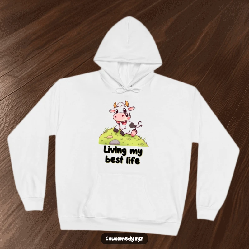 Funny Hoodie: A happy cow sliding down a grassy hill with wide, delighted eyes, offering cozy comfort and a joyful design.