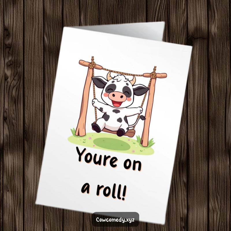 Free Printable Kawaii Cow Congratulations Card showing a happy cow character enthusiastically swinging on a rope swing, celebrating a great accomplishment.