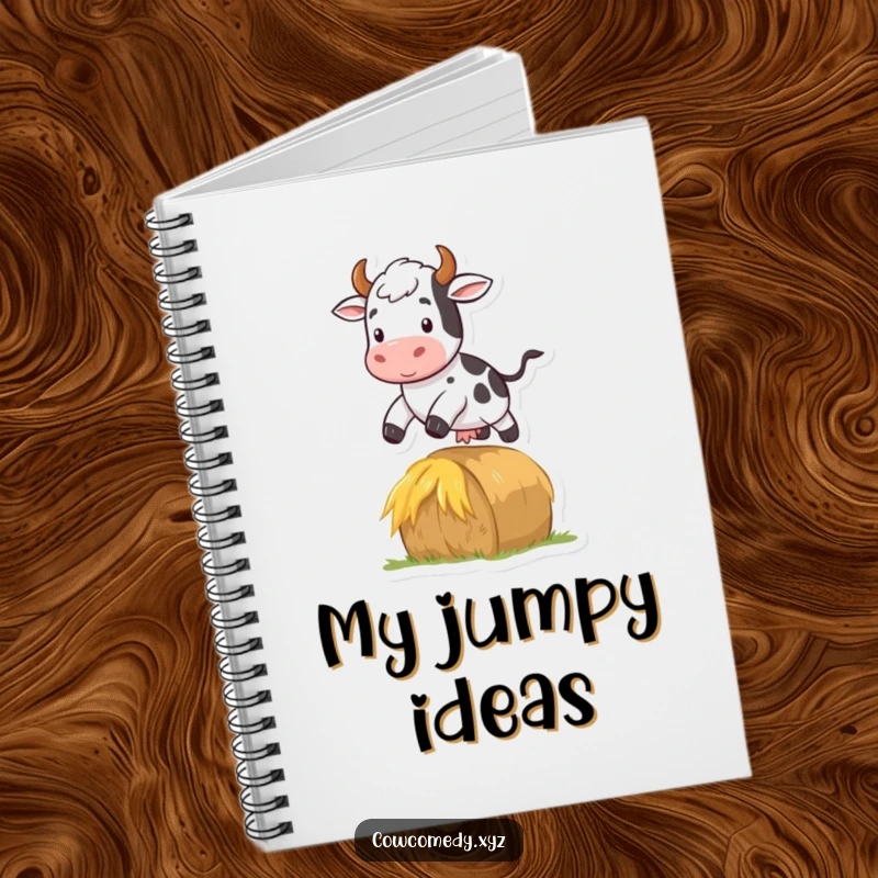 Funny notebook cover with a cow jumping over a hay bale, representing farm dynamism and quick thinking.