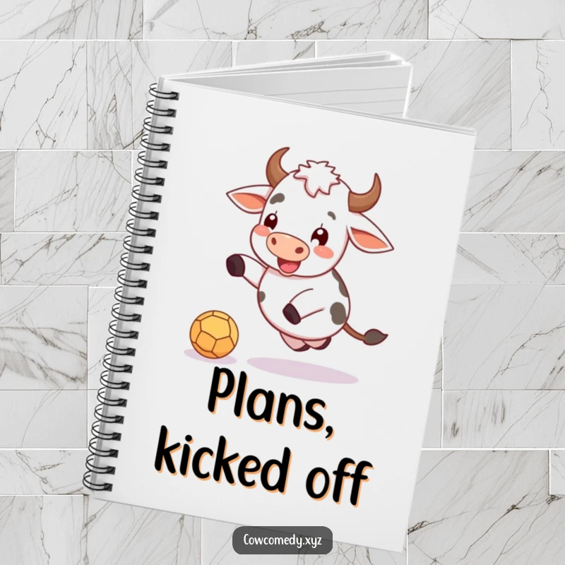 Funny notebook cover with a cheerful cow actively kicking a small, round ball.